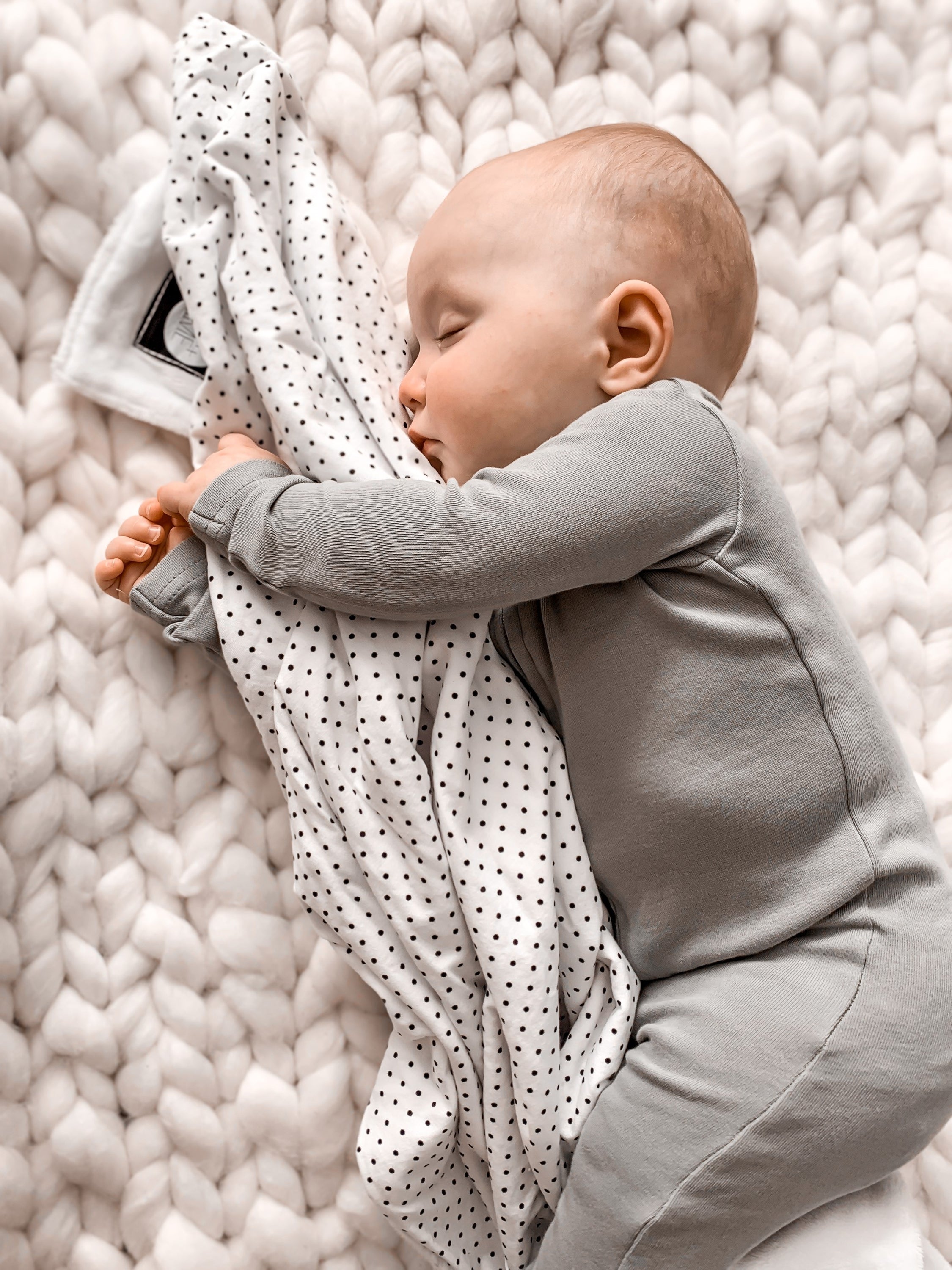 Connect the Dots Baby Blanket featuring a modern black and white dot design, made from 100% cotton percale with a soft minky backing.