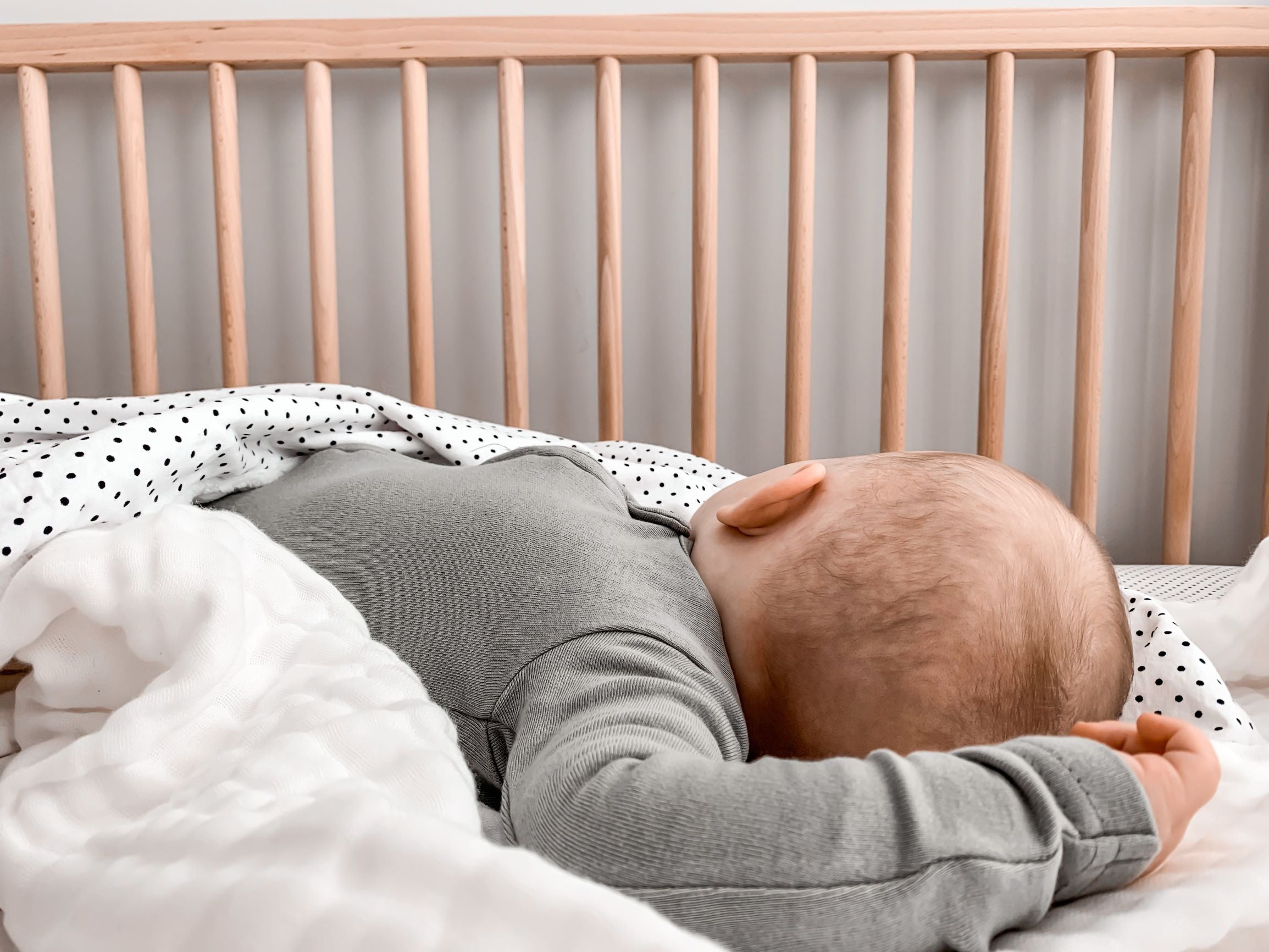 Connect the Dots Classic Crib Bedding Set featuring black dots on a white background, including a crib sheet, skirt, and soft blanket.