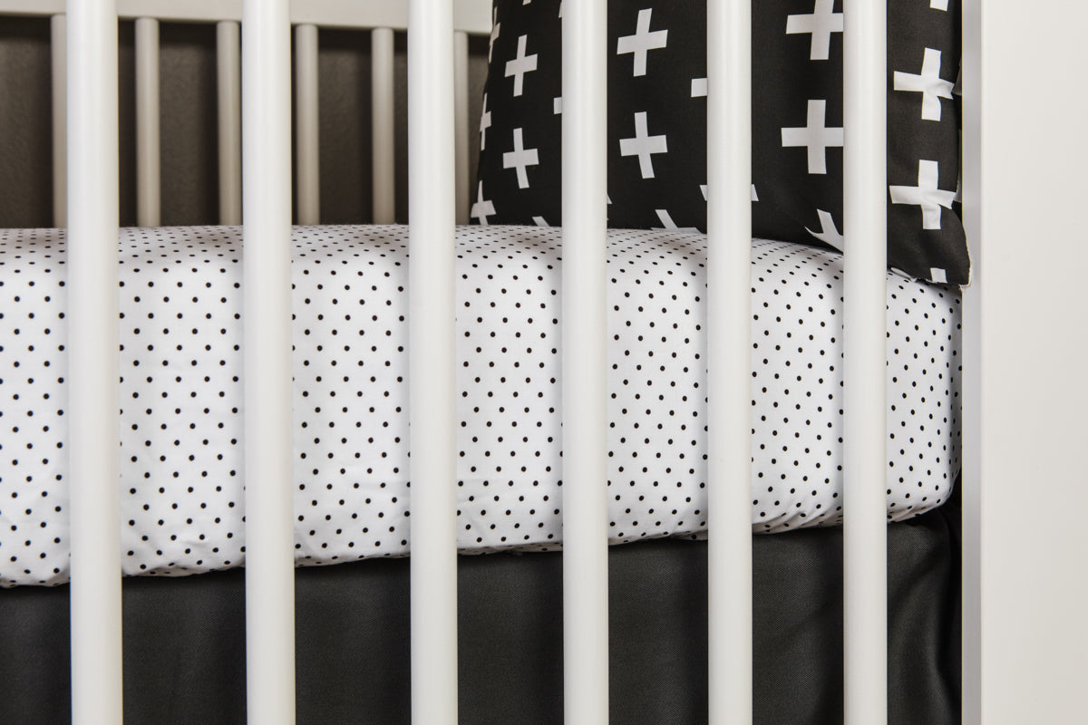 Connect the Dots Fitted Crib Sheet featuring playful black dots on a white background, made from 100% cotton percale for ultimate comfort.