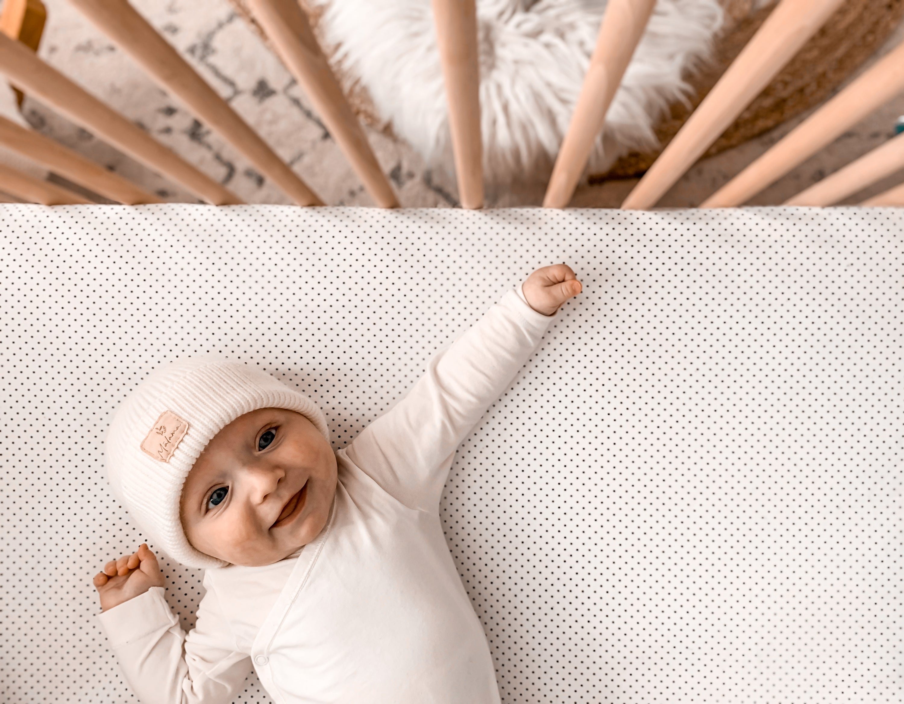 Connect the Dots Fitted Crib Sheet featuring playful black dots on a white background, made from 100% cotton percale for ultimate comfort.