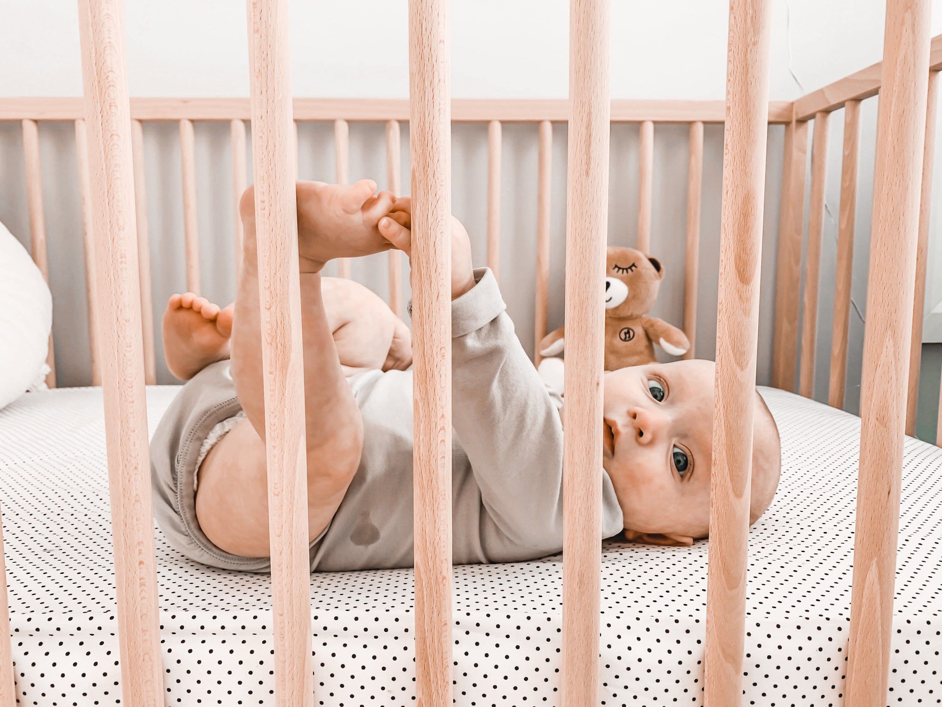 Connect the Dots Fitted Crib Sheet featuring playful black dots on a white background, made from 100% cotton percale for ultimate comfort.