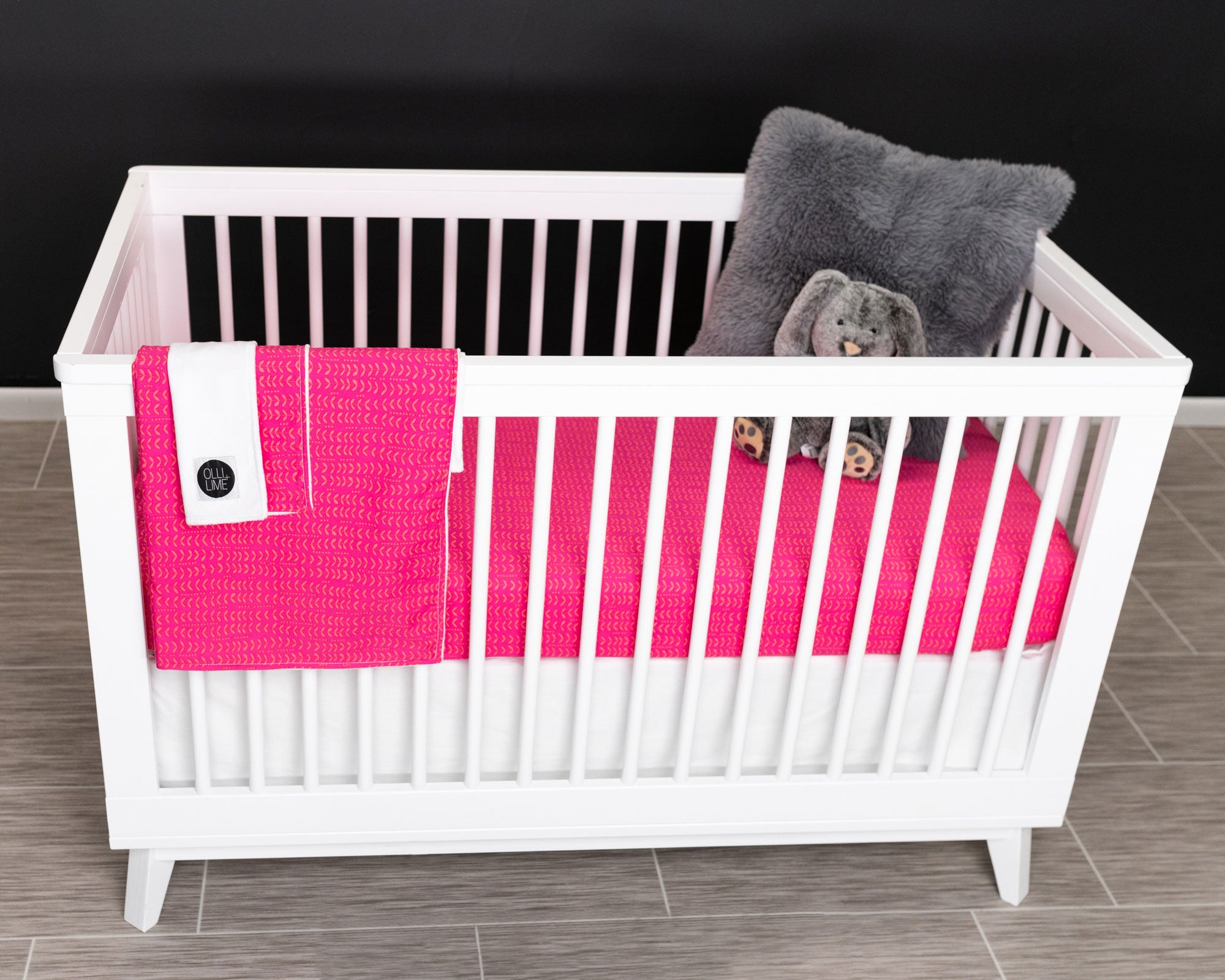 Dreamy Ferns Deluxe Crib Bedding Set featuring marigold ferns on a fuchsia background, including crib skirt, fitted sheet, baby blanket, and lovey.