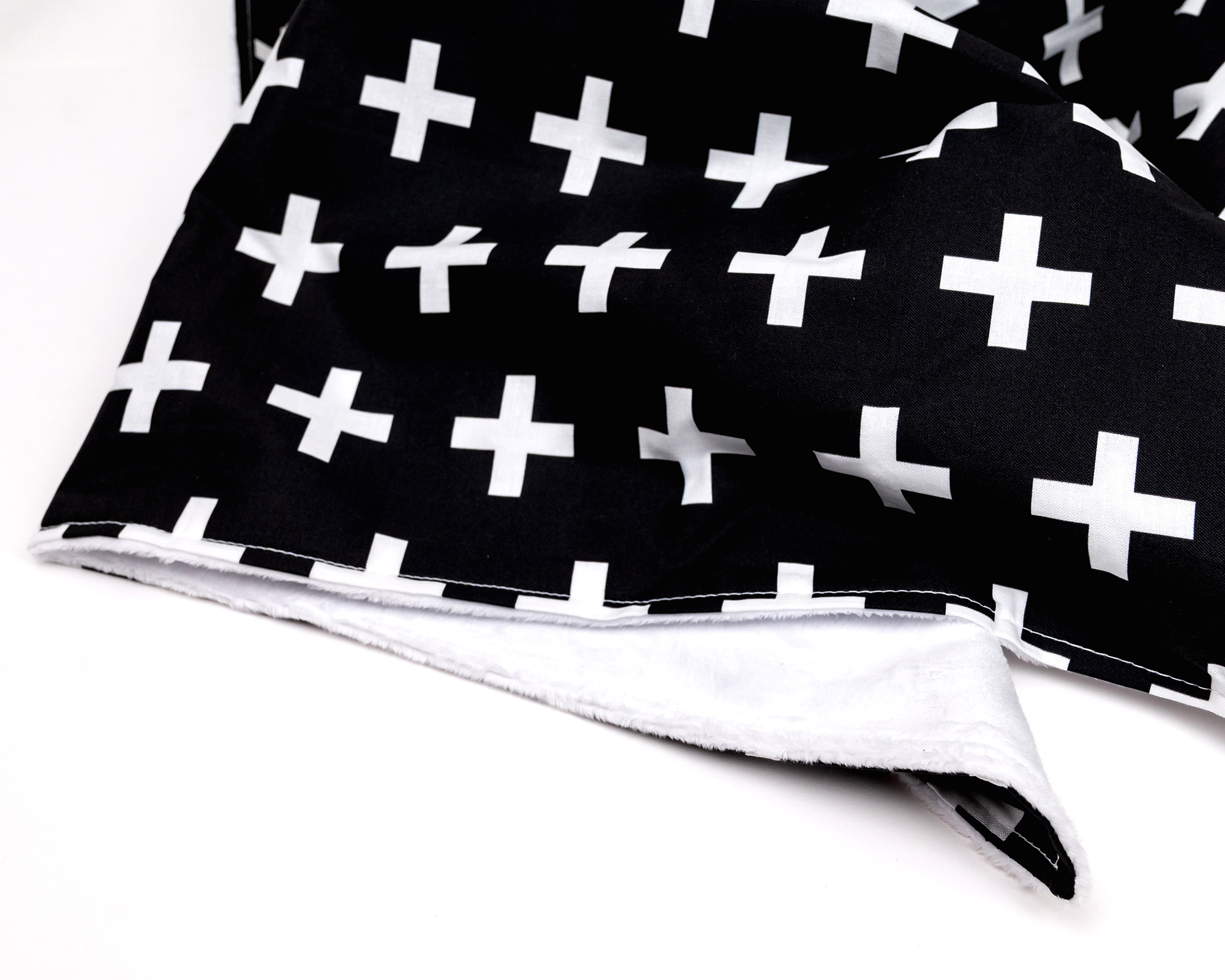 Finn Baby Blanket featuring a large white Swiss cross on a black background, made from 100% premium cotton with a soft minky backing.