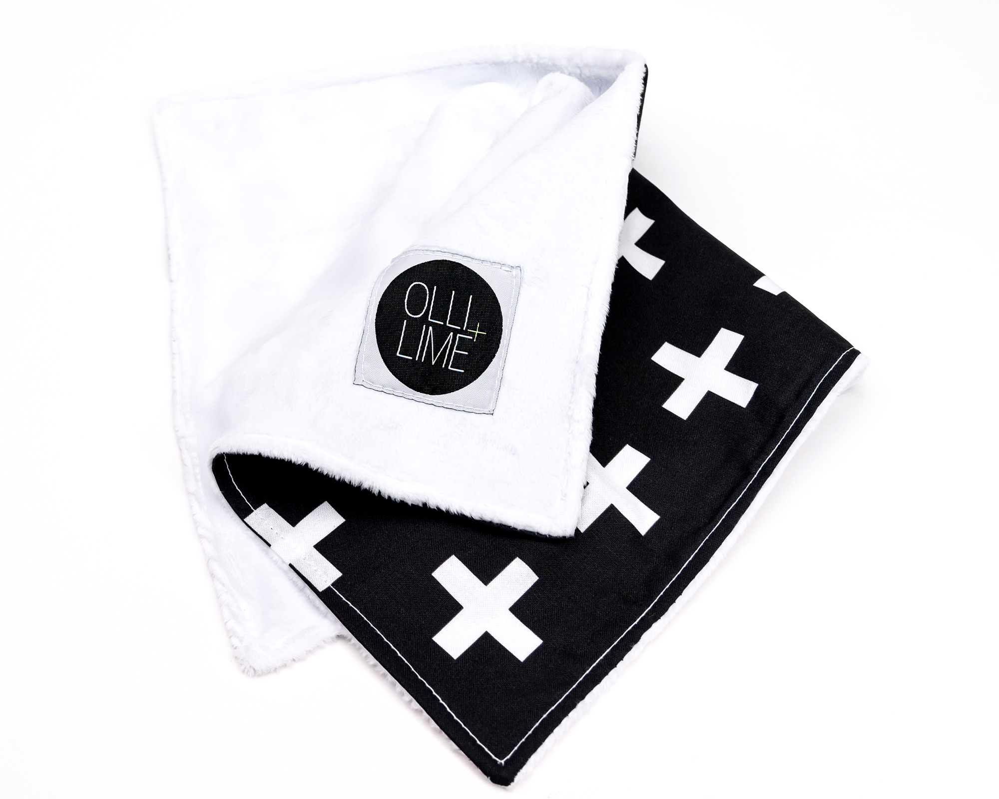 Finn Lovey security blanket featuring a white Swiss cross pattern on a black background, made from premium cotton with a soft minky backing.