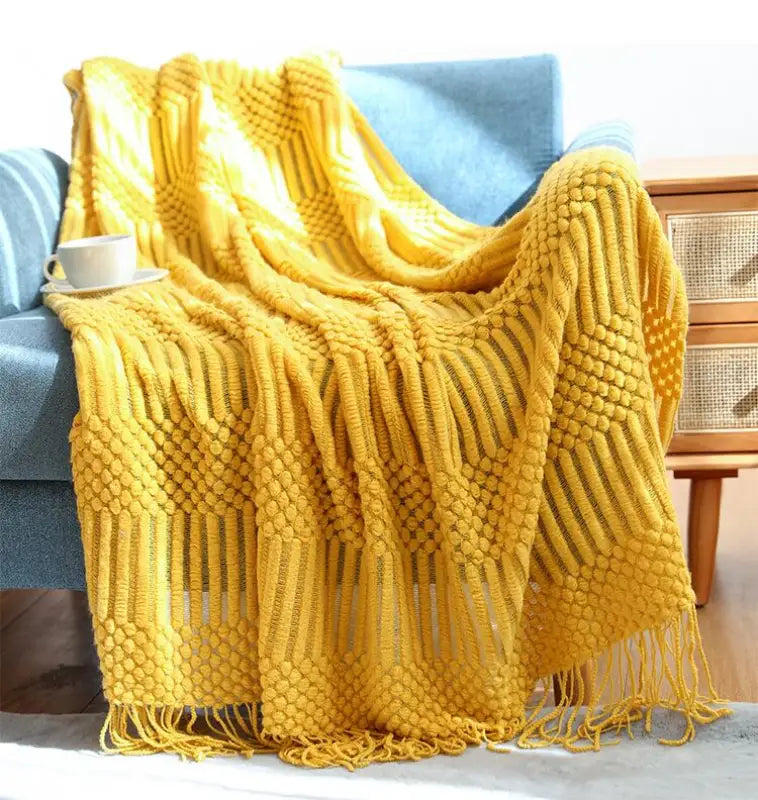 A cozy hand knitted tassel throw blanket in soft imitation cashmere, featuring intricate tassels and a stylish bohemian design.