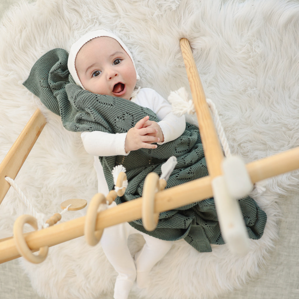 Heart Knit Baby Blanket made from 100% soft natural cotton, featuring a timeless heart theme design in gender-neutral colors, perfect for newborns.