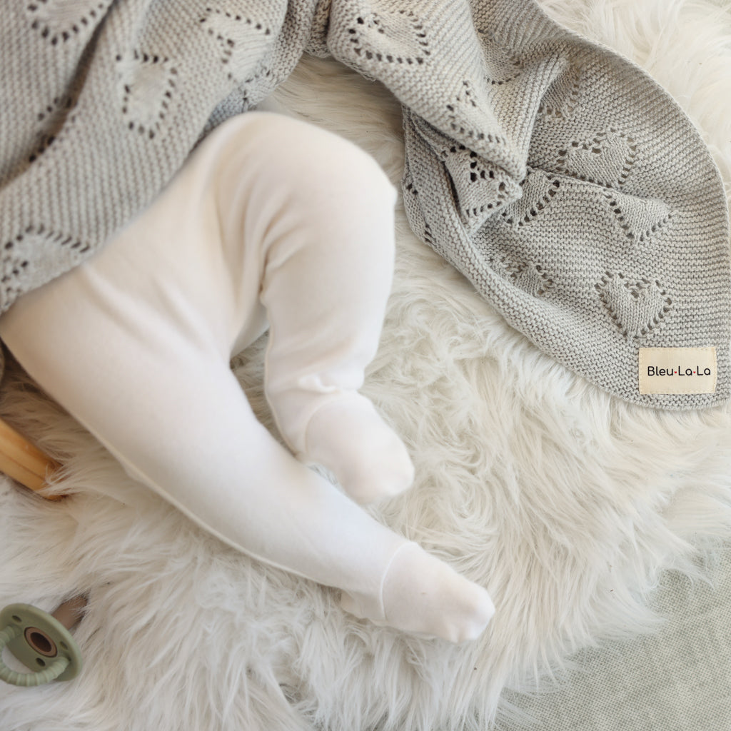 Heart Knit Baby Blanket made from 100% soft natural cotton, featuring a timeless heart theme design in gender-neutral colors, perfect for newborns.