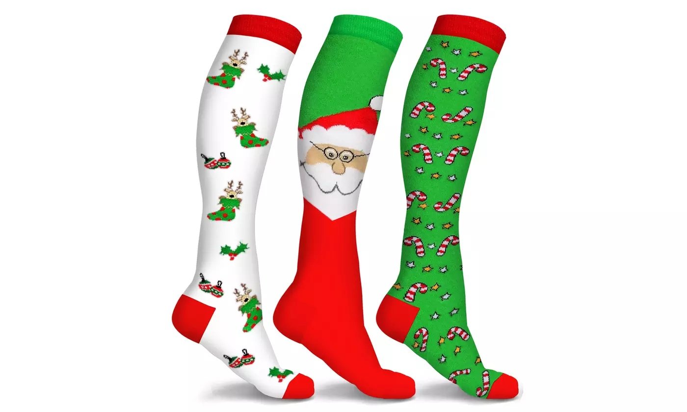 Three pairs of Holiday Fun Knee High Compression Socks featuring festive designs like reindeer and candy cane, showcasing their knee-high length and vibrant colors.