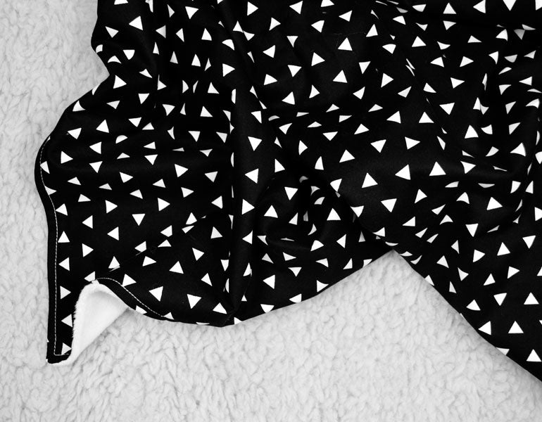 Kingsley Baby Blanket featuring modern triangle design in black and white, soft cotton front and minky back.