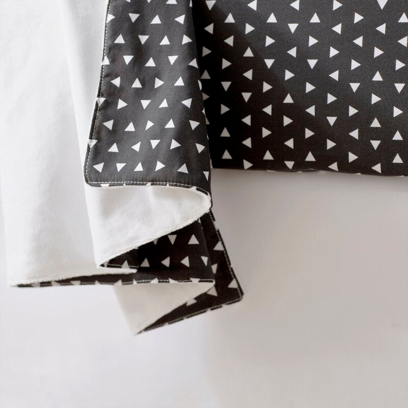 Kingsley Baby Blanket featuring modern triangle design in black and white, soft cotton front and minky back.