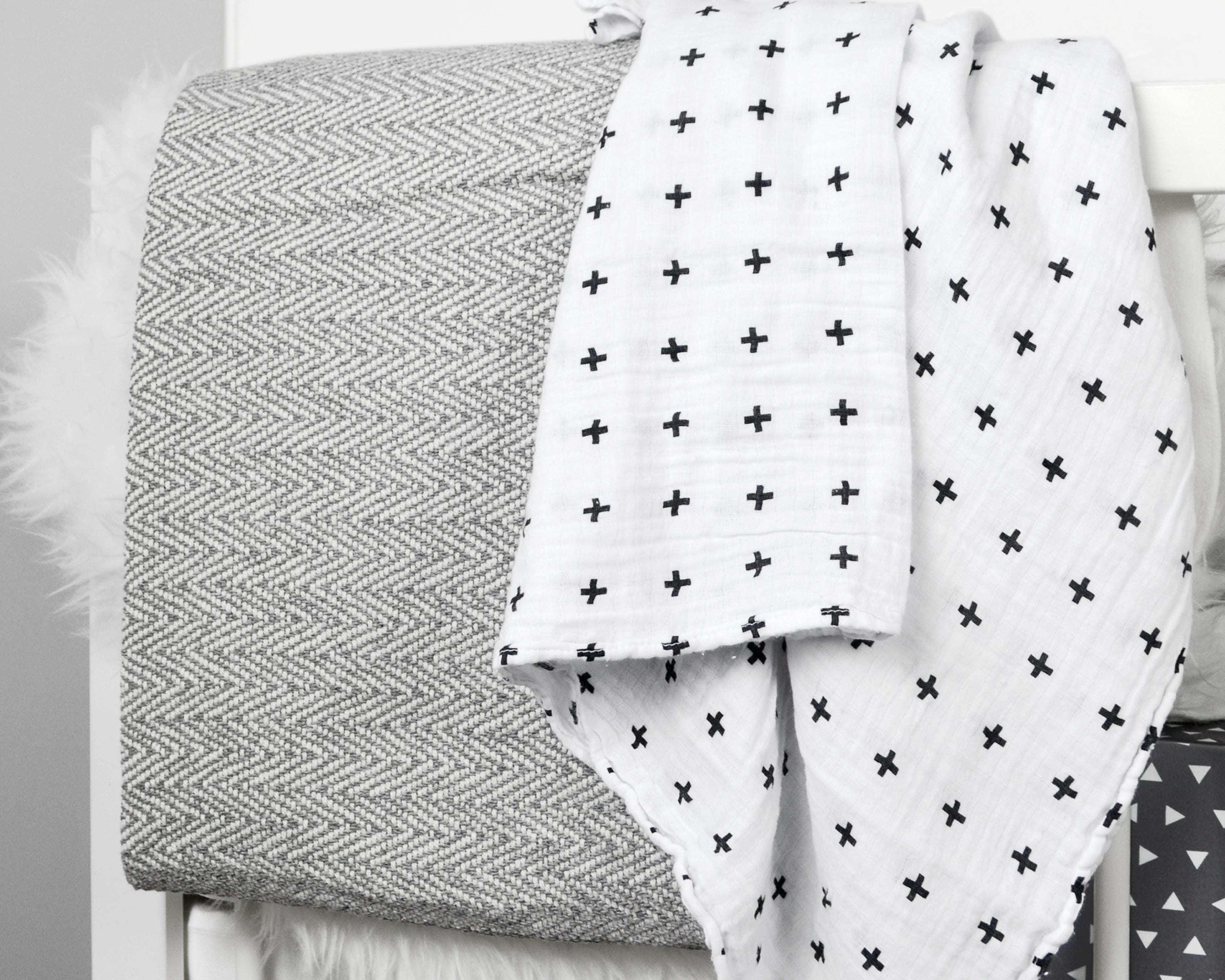 Kingsley Deluxe Crib Bedding Set featuring modern triangle designs in black and white with a grey weave blanket, perfect for stylish nurseries.