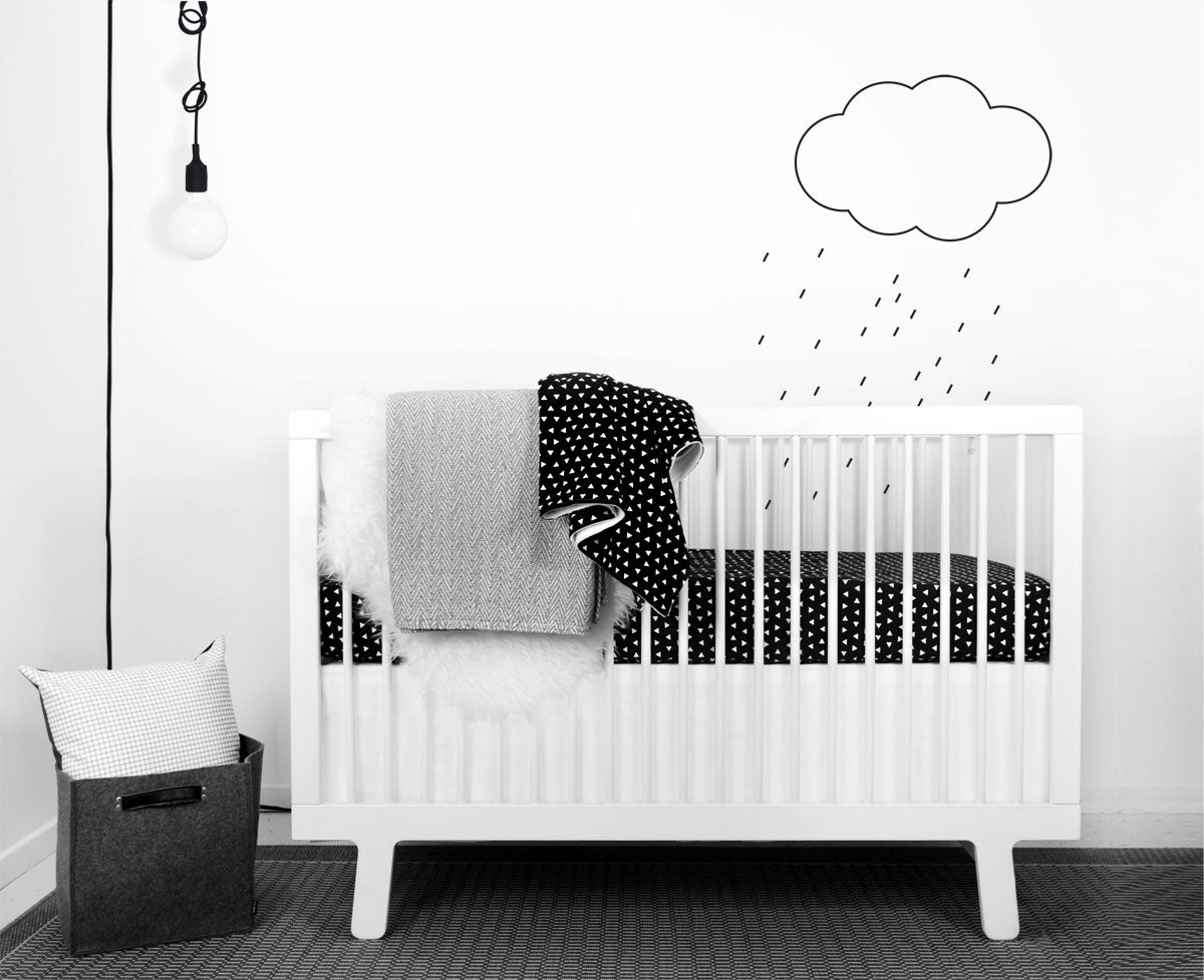 Kingsley Deluxe Crib Bedding Set featuring modern triangle designs in black and white with a grey weave blanket, perfect for stylish nurseries.