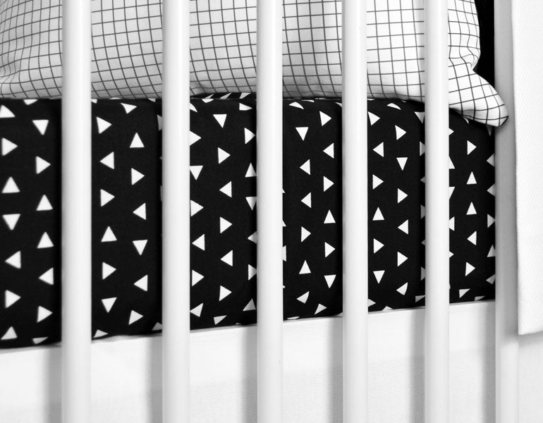 Kingsley Deluxe Crib Bedding Set featuring modern triangle designs in black and white with a grey weave blanket, perfect for stylish nurseries.