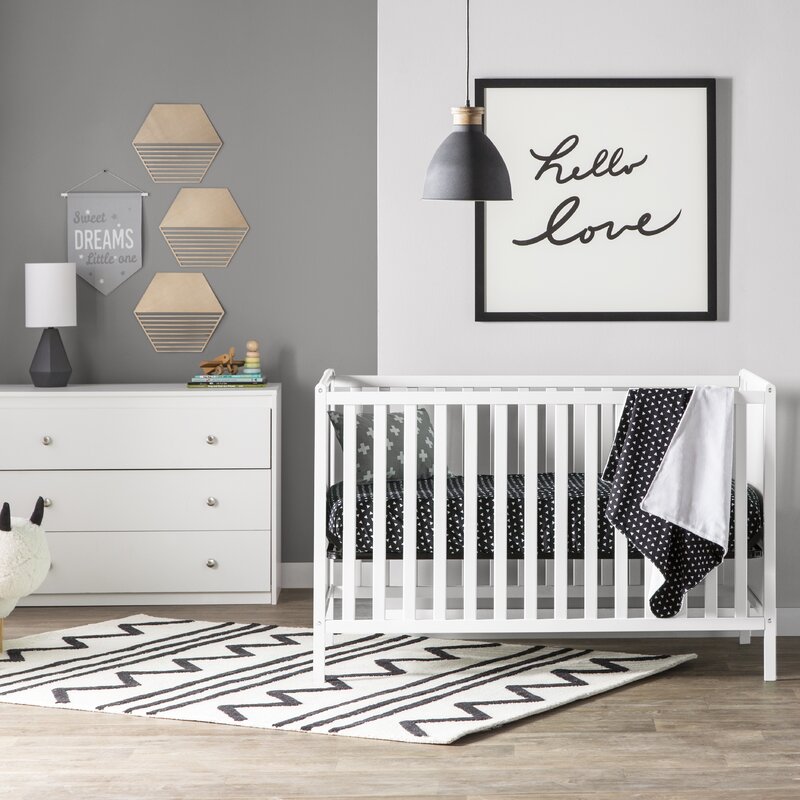 Kingsley Deluxe Crib Bedding Set featuring modern triangle designs in black and white with a grey weave blanket, perfect for stylish nurseries.