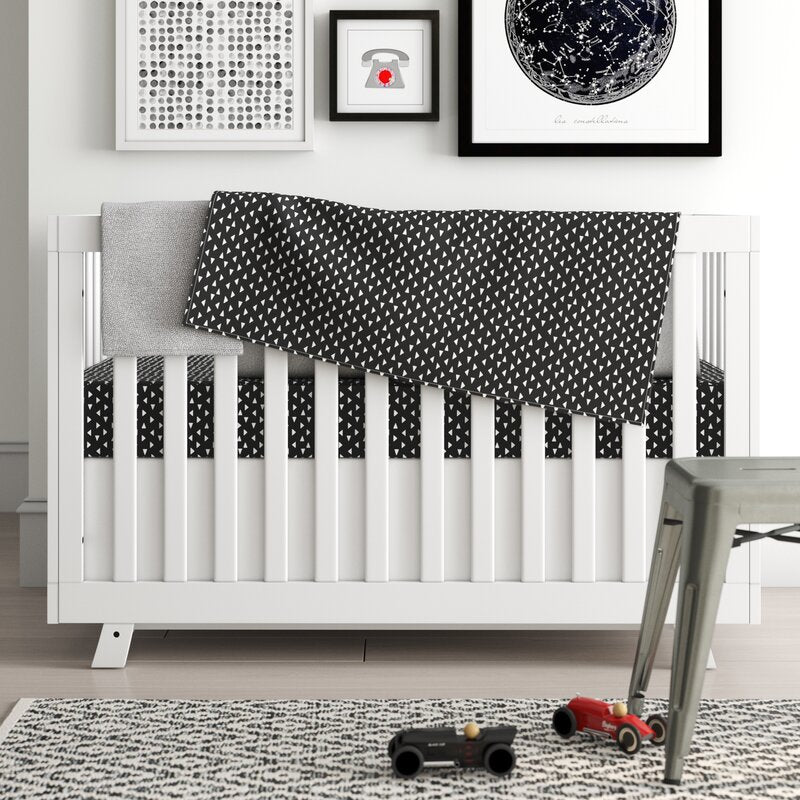 Kingsley Deluxe Crib Bedding Set featuring modern triangle designs in black and white with a grey weave blanket, perfect for stylish nurseries.