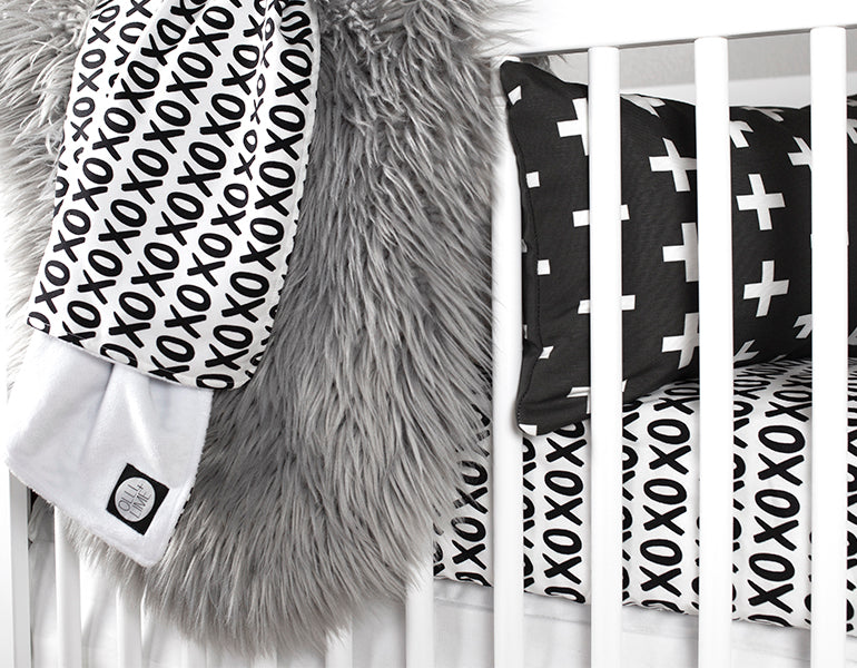 Mega XO Fitted Crib Sheet featuring black X's and O's on a white background, designed for modern nurseries.