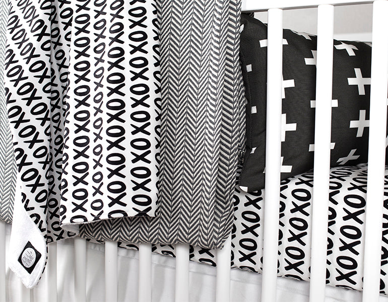 Mega XO Fitted Crib Sheet featuring black X's and O's on a white background, designed for modern nurseries.