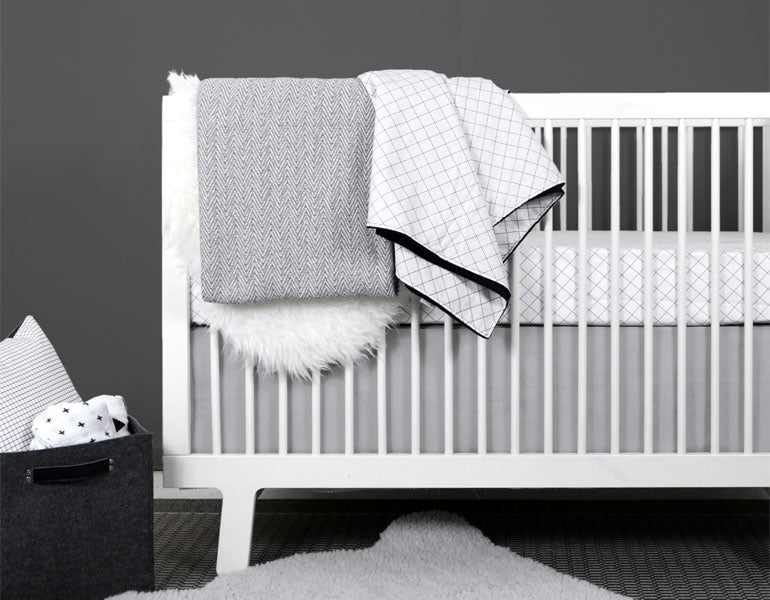 Light gray crib skirt with a crisp tailored design, made from heavyweight cotton twill, perfect for standard cribs.