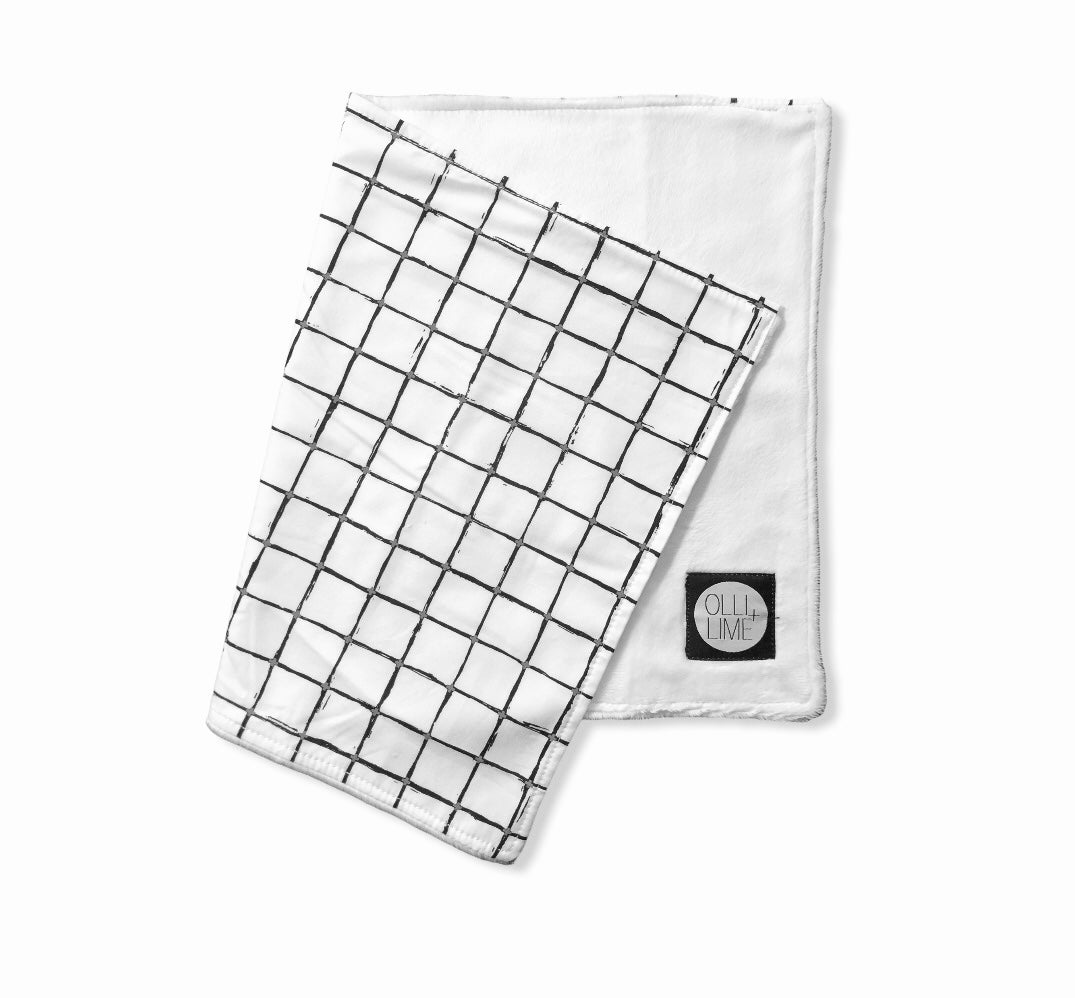 Luca Lovey security blanket featuring a modern black and white grid design, made from soft minky fabric and 100% cotton percale.