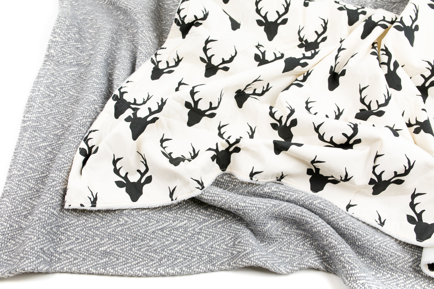 Mila Baby Blanket featuring a modern woodland deer design in off-white and black, with a soft minky backing, perfect for nurseries.