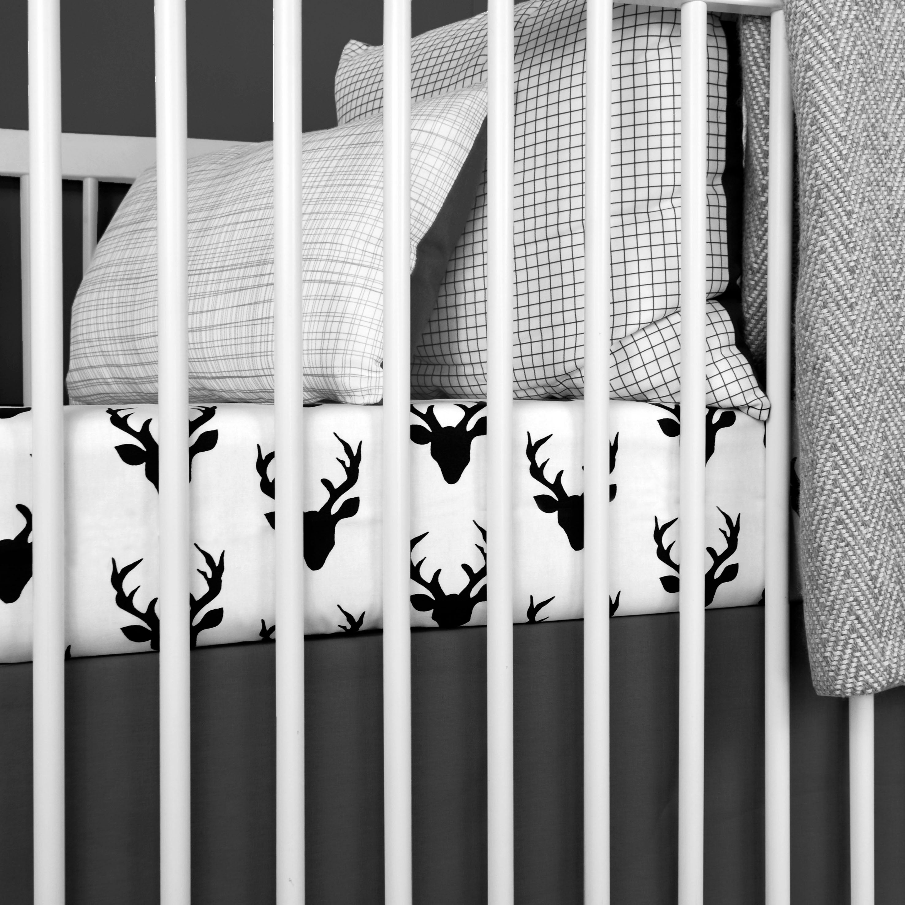 Mila Classic Crib Bedding Set featuring modern woodland deer design in soft cotton fabric, including a plush minky blanket and fitted sheet.