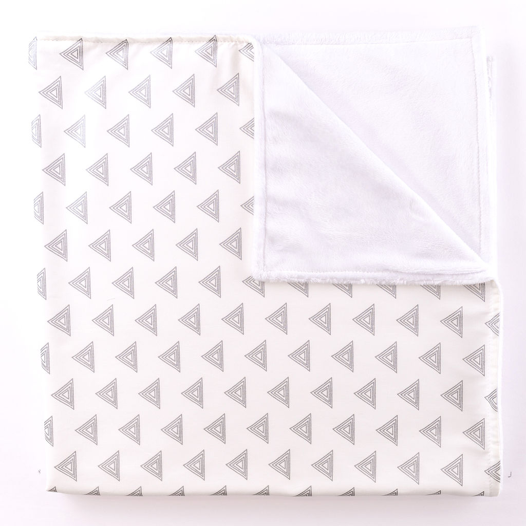 My Little Hat Baby Blanket featuring light gray triangles on an ivory background, perfect for a stylish nursery.