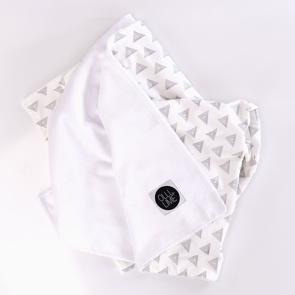 My Little Hat Baby Blanket featuring light gray triangles on an ivory background, perfect for a stylish nursery.