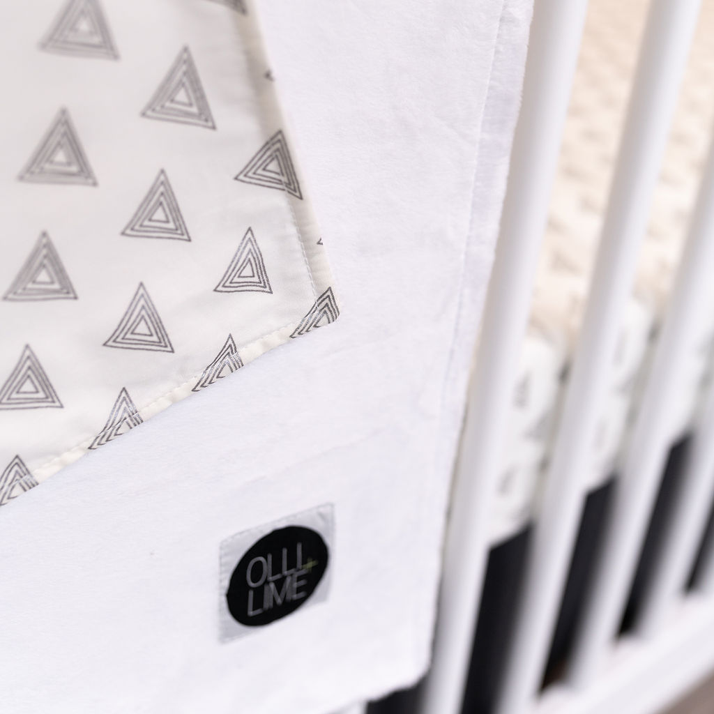 My Little Hat Baby Blanket featuring light gray triangles on an ivory background, perfect for a stylish nursery.