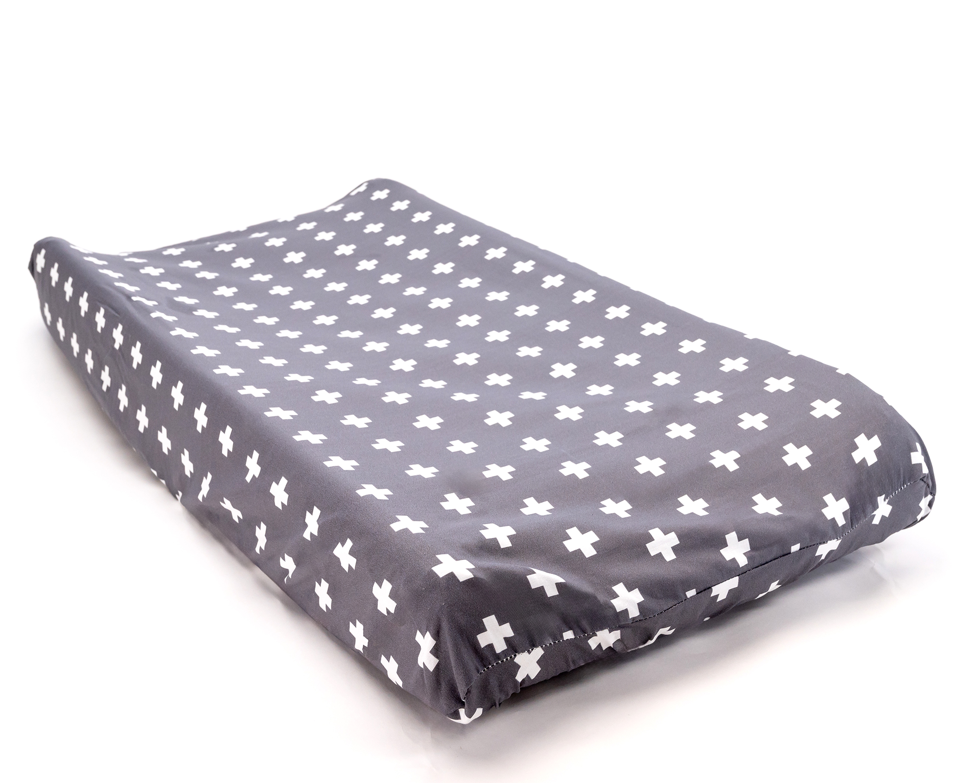 Nils Changing Pad Cover featuring a white Swiss cross pattern on a dark gray background, designed for modern nurseries.