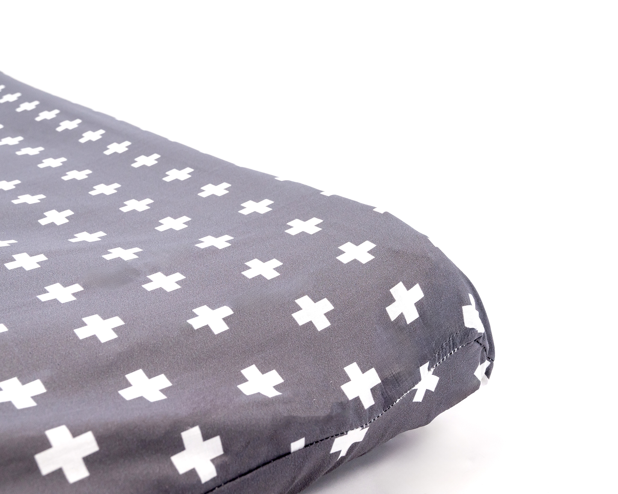 Nils Changing Pad Cover featuring a white Swiss cross pattern on a dark gray background, designed for modern nurseries.