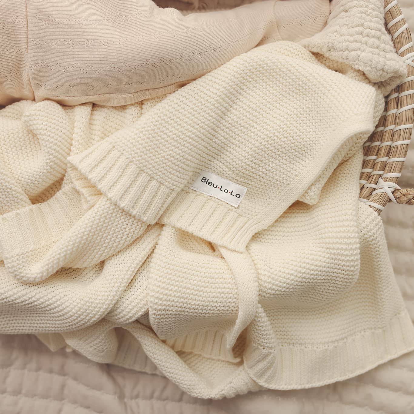 Organic Cotton Luxury Knit Baby Swaddle Blanket in soft pastel colors, showcasing its gentle texture and versatile design for newborns and toddlers.