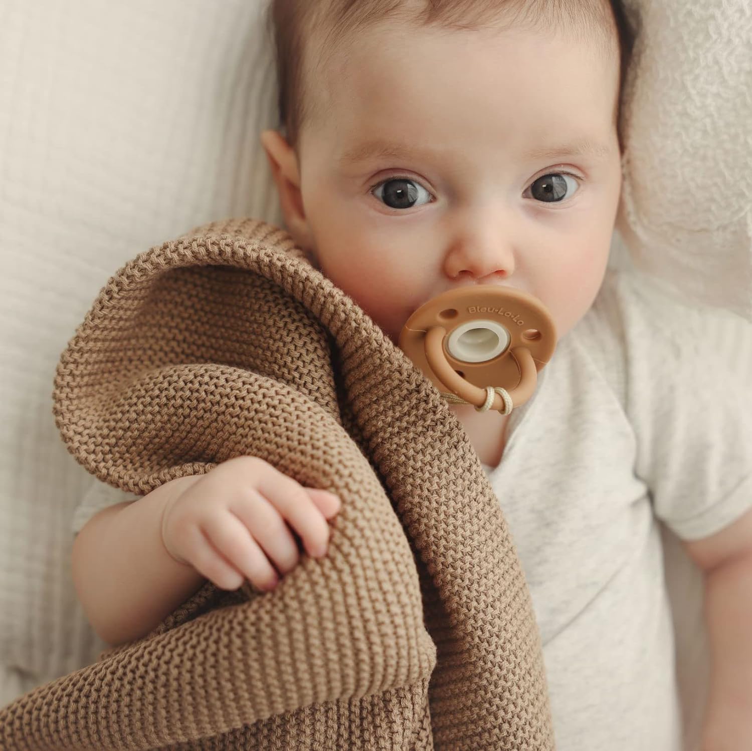 Organic Cotton Luxury Knit Baby Swaddle Blanket in soft pastel colors, showcasing its gentle texture and versatile design for newborns and toddlers.