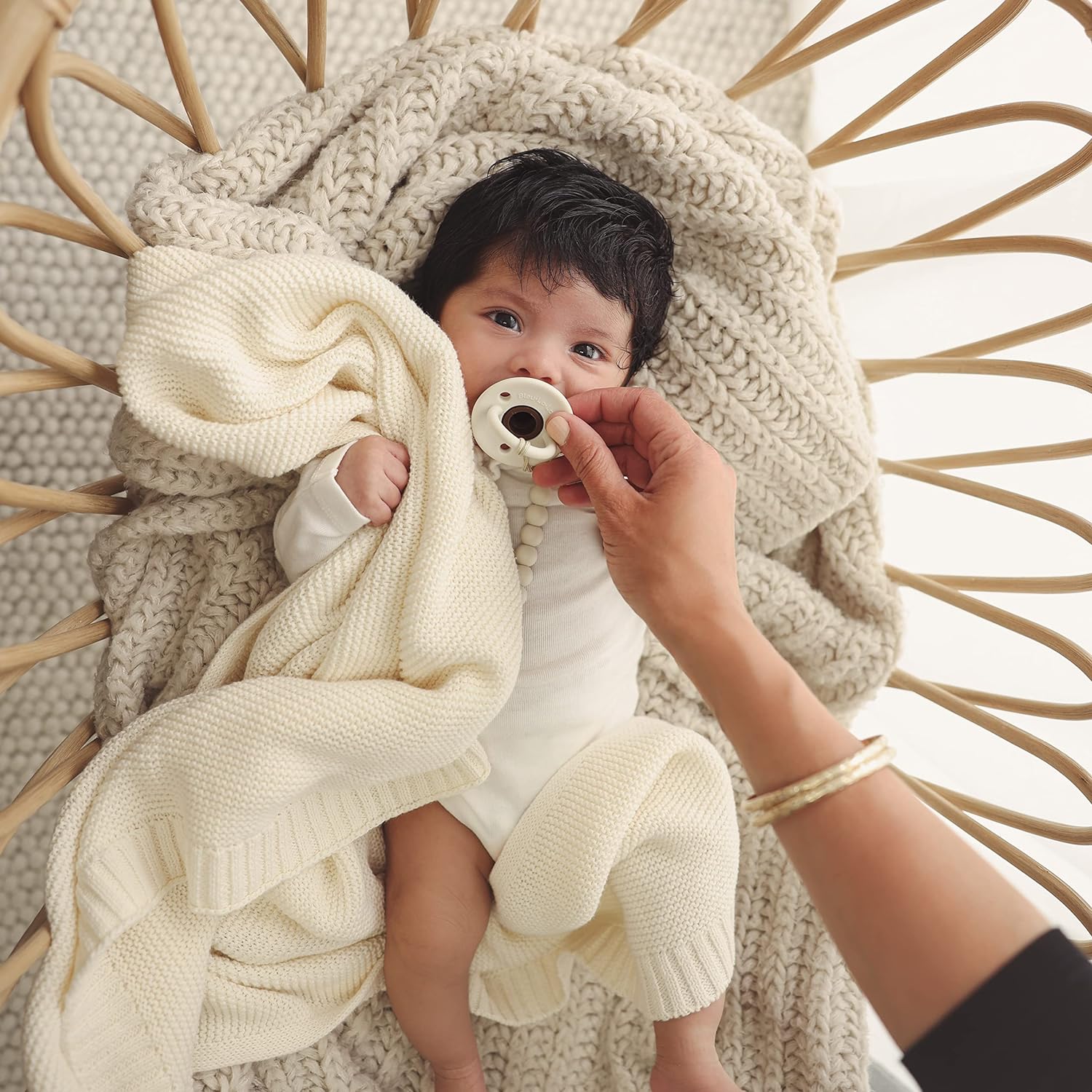 Organic Cotton Luxury Knit Baby Swaddle Blanket in soft pastel colors, showcasing its gentle texture and versatile design for newborns and toddlers.