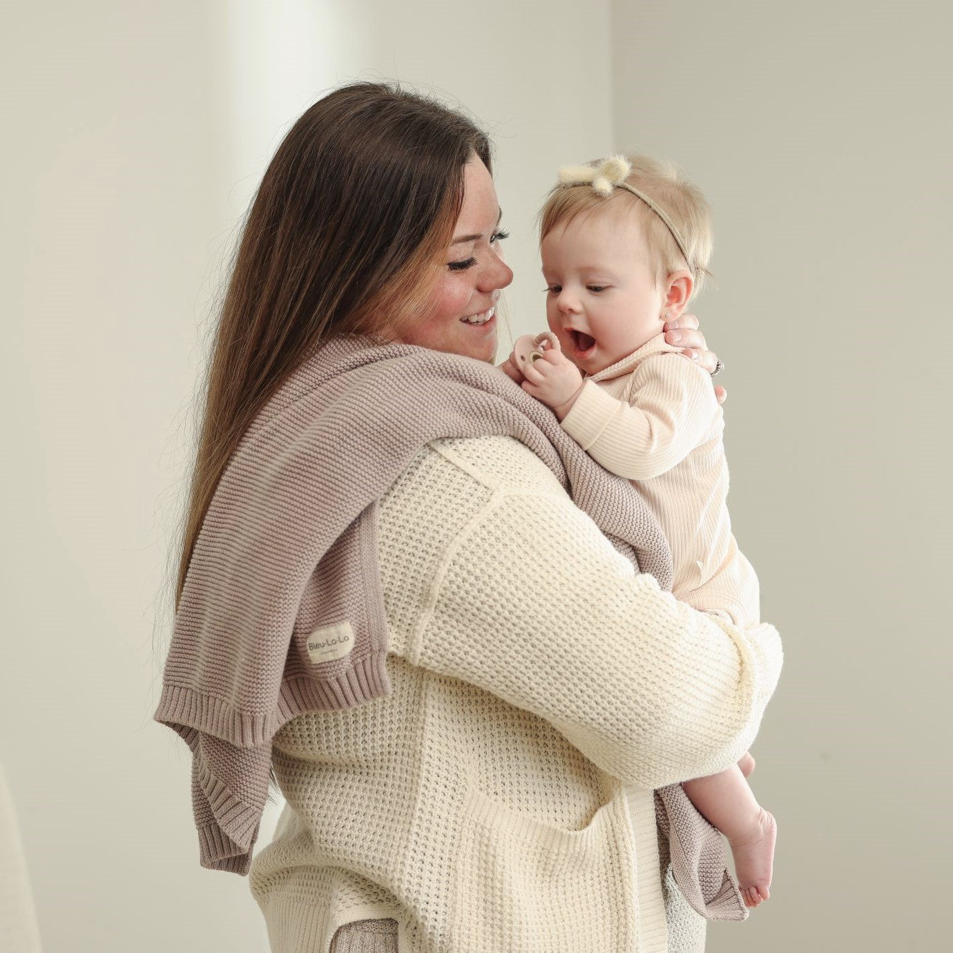 Organic Cotton Luxury Knit Baby Swaddle Blanket in soft pastel colors, showcasing its gentle texture and versatile design for newborns and toddlers.