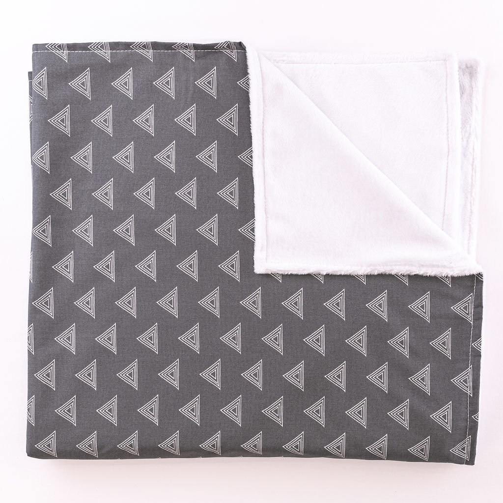 Tops for Tots Baby Blanket featuring light gray triangles on a dark gray background, made from 100% premium cotton with plush minky backing.