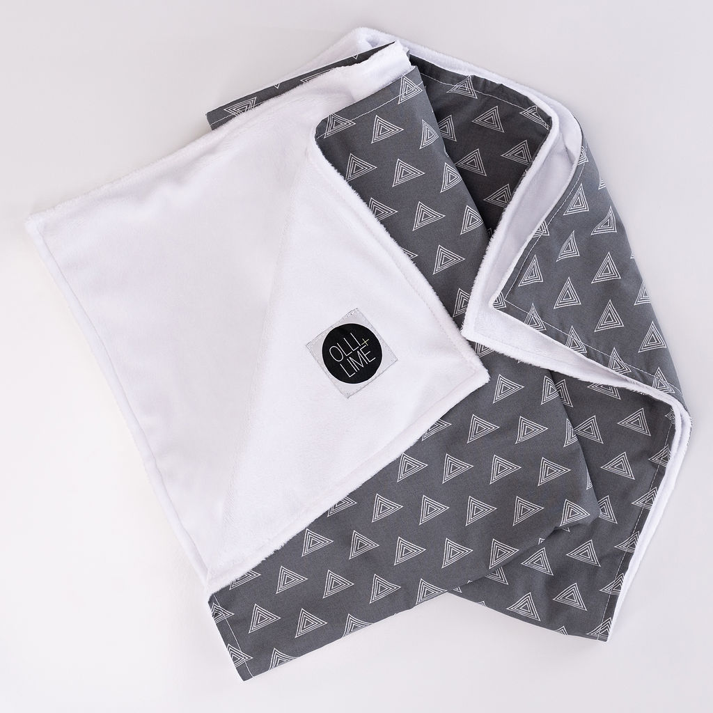 Tops for Tots Baby Blanket featuring light gray triangles on a dark gray background, made from 100% premium cotton with plush minky backing.