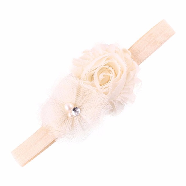 Ivory flower embellished headband.