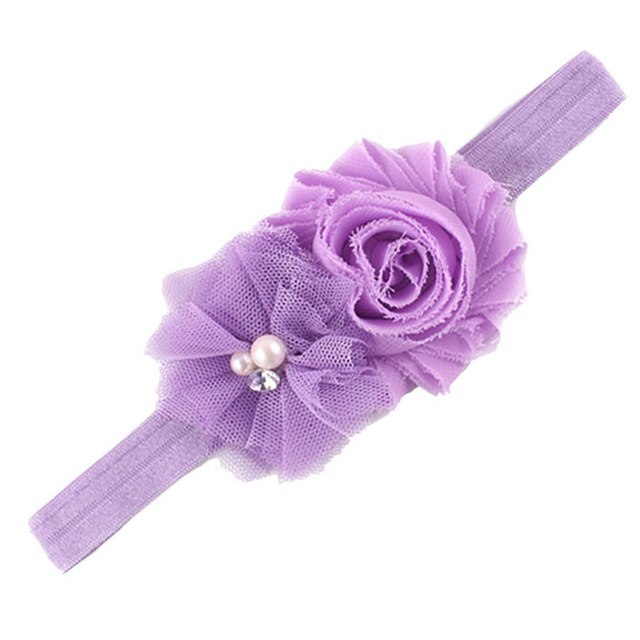 Purple headband with fabric flowers.