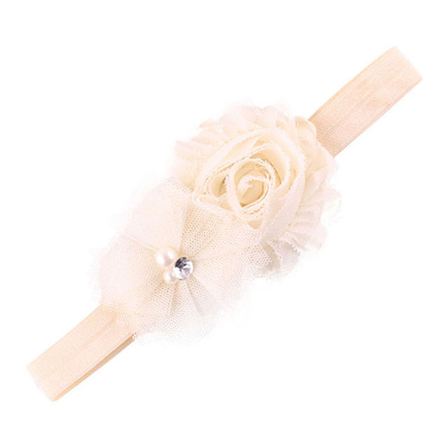 Cream headband with flower embellishment.