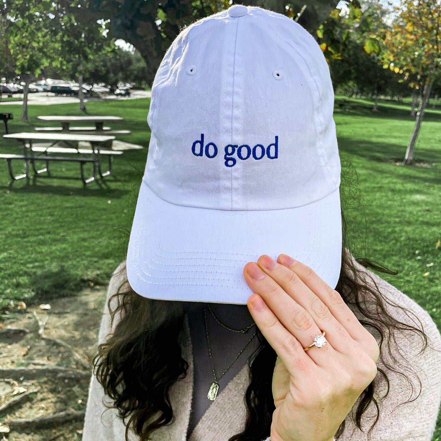 A stylish Blank Canvas White Baseball Hat featuring 'Do Good' embroidery, adjustable strap, and made from 100% cotton, perfect for casual wear.