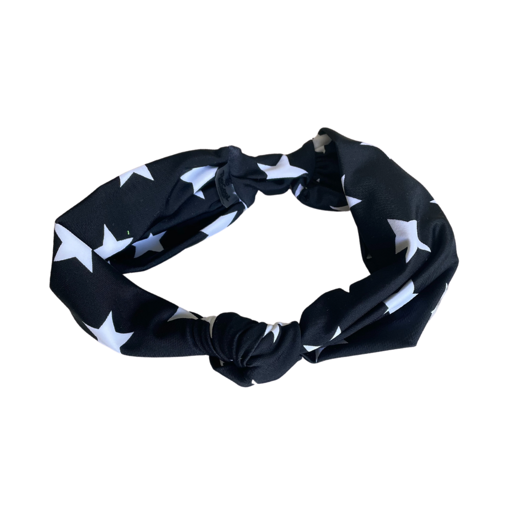 A stylish black headband adorned with white stars, suitable for both kids and adults, showcasing its trendy design and stretchy fit.