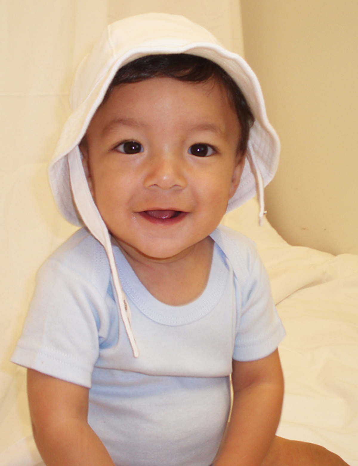 Smiling baby wearing a hat.