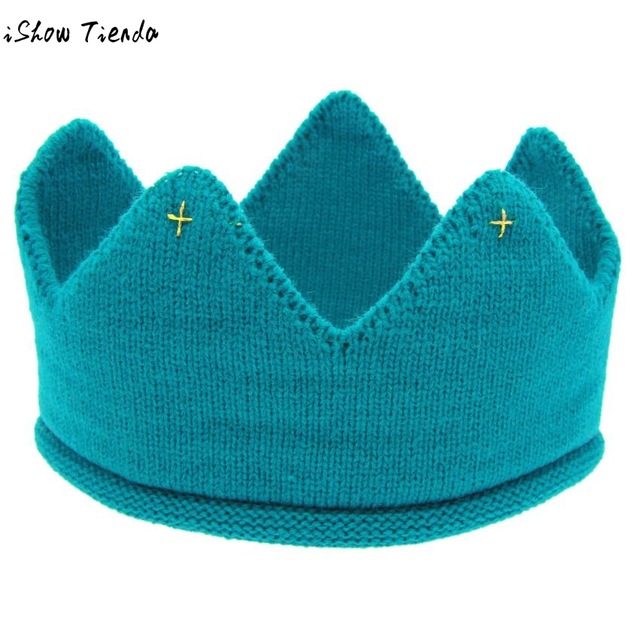 A cute baby wearing a knitted crown-shaped hat, showcasing a soft cotton material in a playful cartoon pattern, perfect for newborns and toddlers.