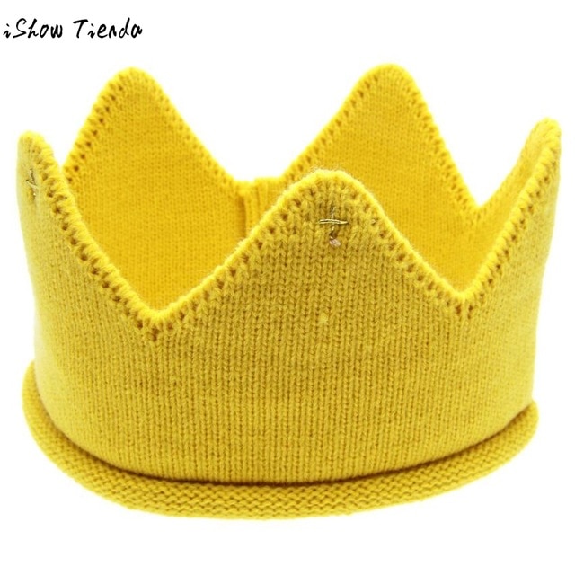 A cute baby wearing a knitted crown-shaped hat, showcasing a soft cotton material in a playful cartoon pattern, perfect for newborns and toddlers.