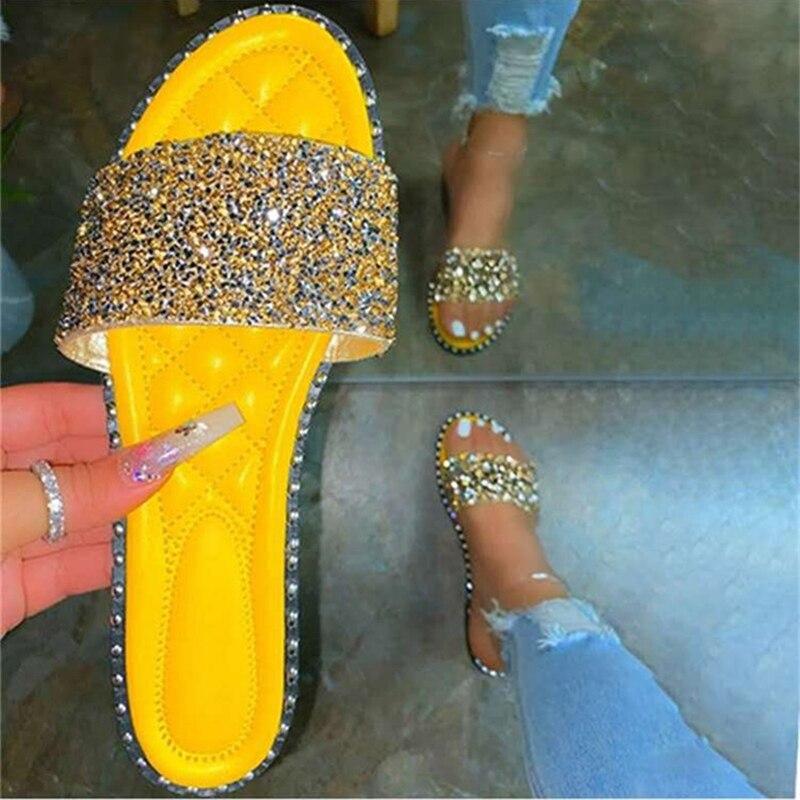 A pair of stylish Crystal Women Slippers featuring bling bling embellishments, perfect for summer beach outings. Lightweight and comfortable design.