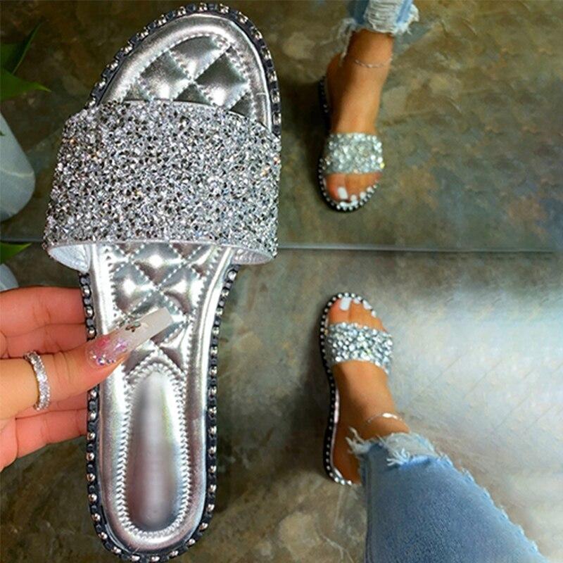 A pair of stylish Crystal Women Slippers featuring bling bling embellishments, perfect for summer beach outings. Lightweight and comfortable design.