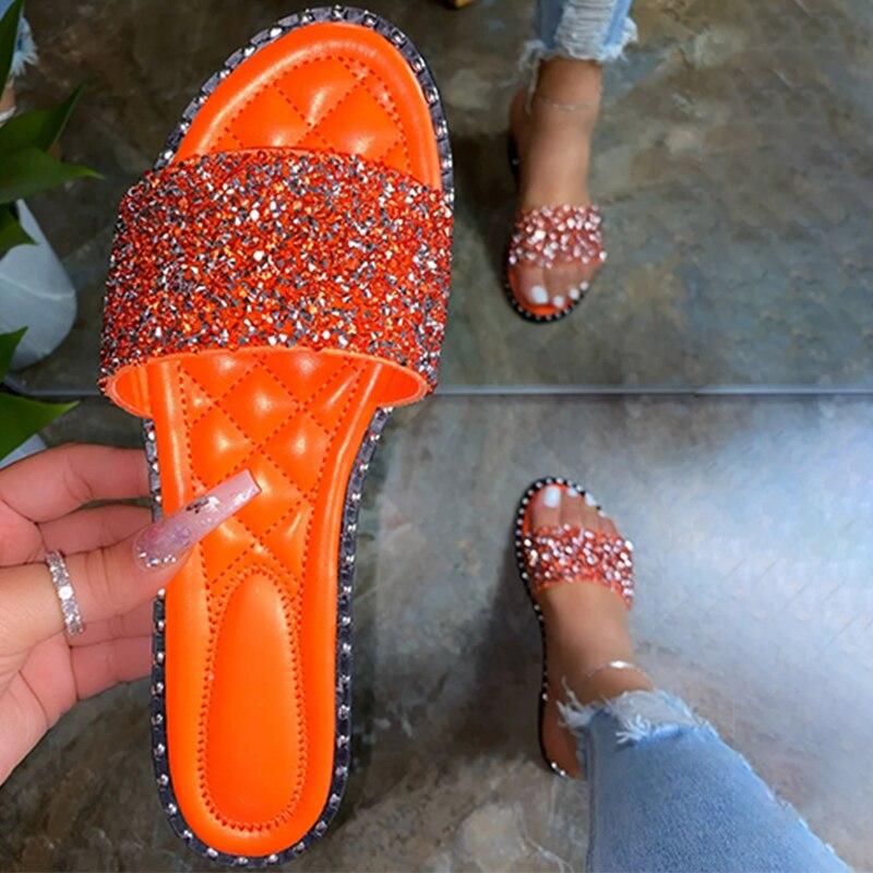 A pair of stylish Crystal Women Slippers featuring bling bling embellishments, perfect for summer beach outings. Lightweight and comfortable design.