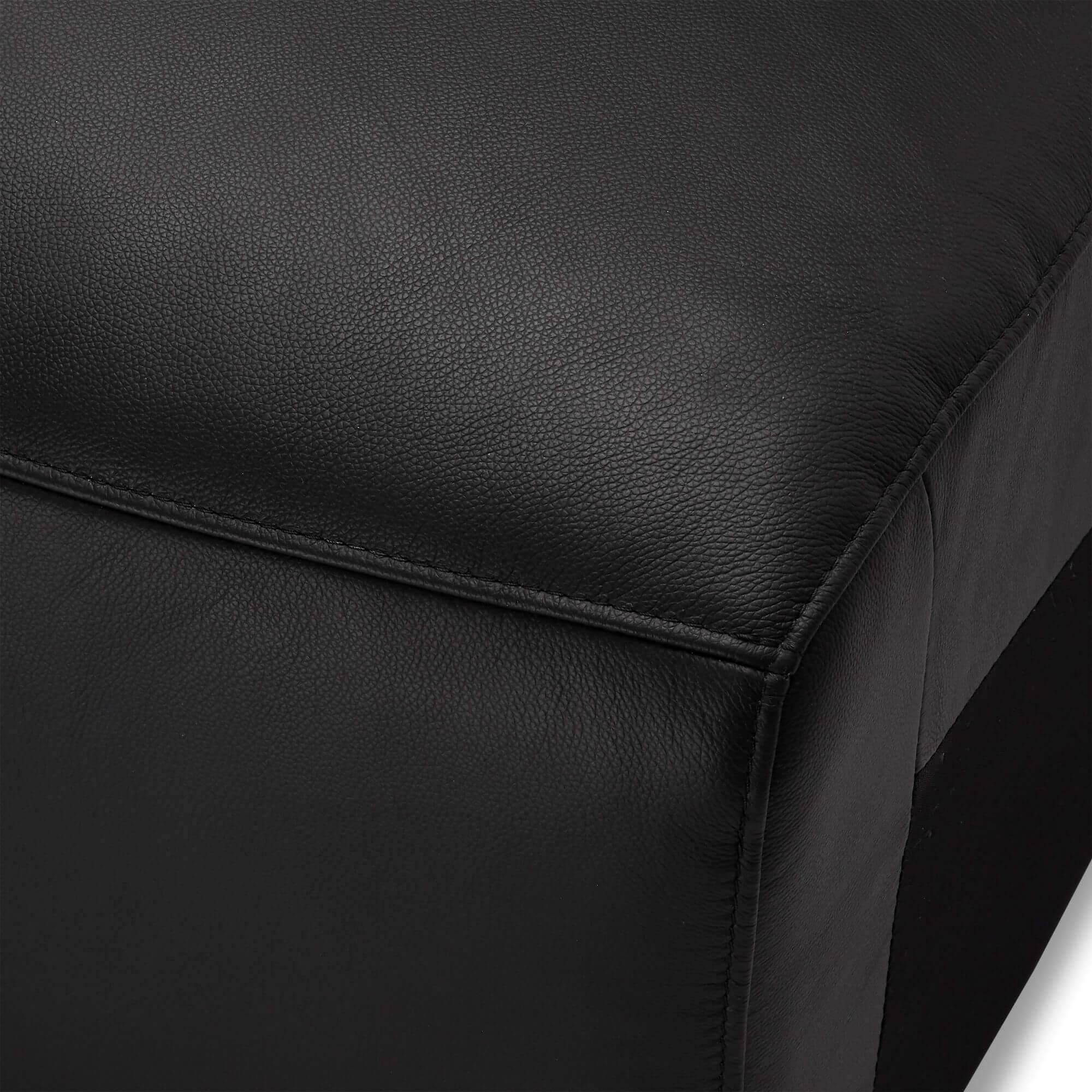 Armless sofa module in black leather, showcasing modern design and rich foam padding.