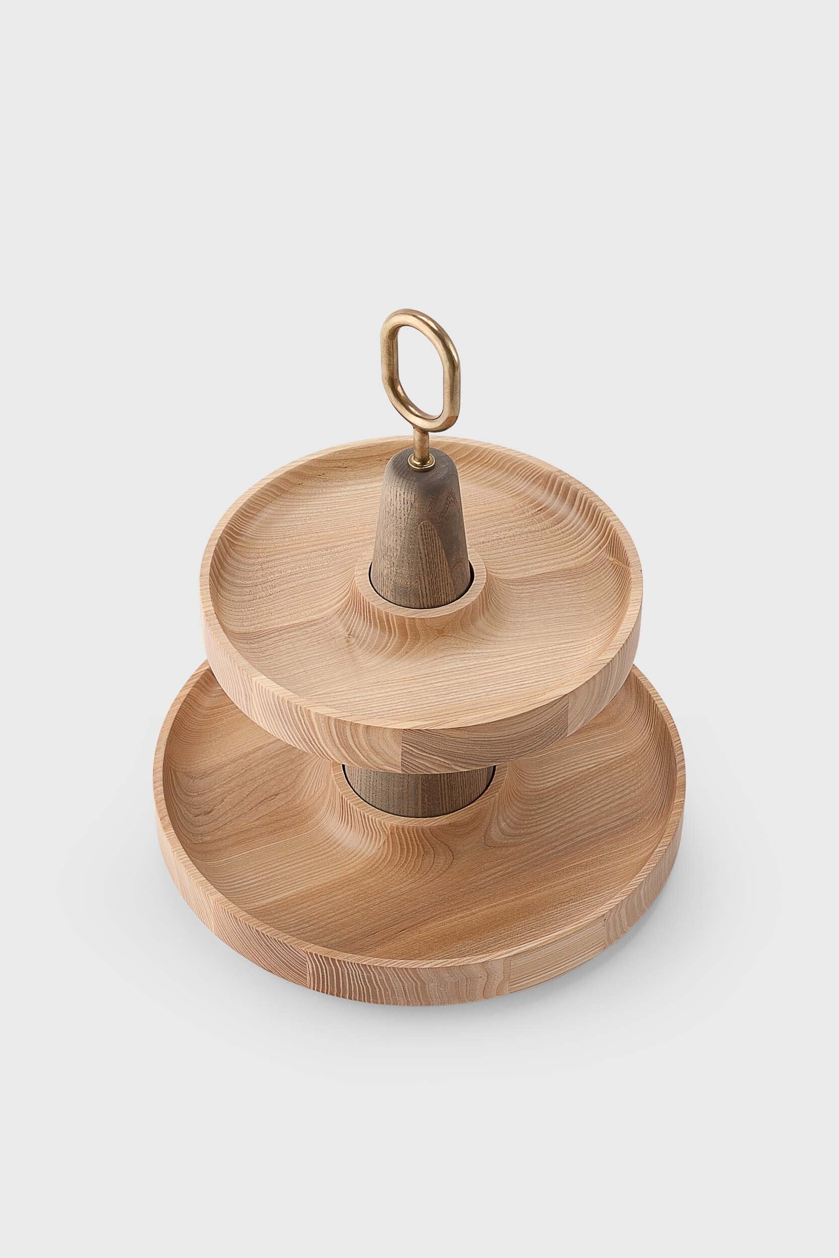 Babel Serving Stand featuring two scooped wooden plates and a brass handle, elegantly designed for serving fruits and desserts.