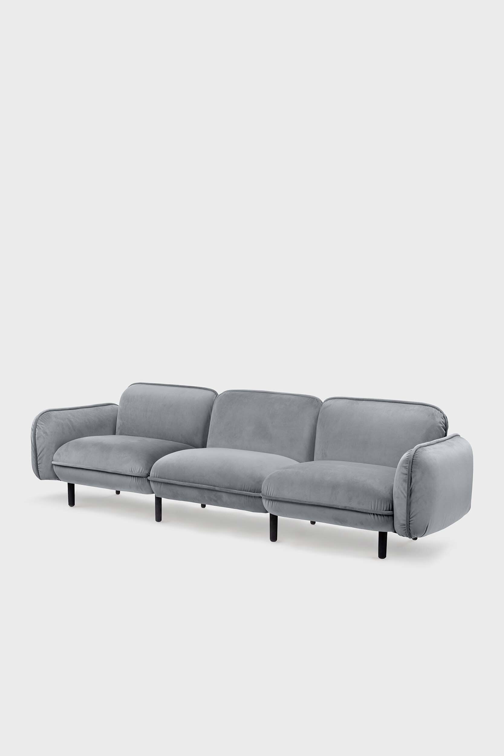 Bean modular sofa with rounded corners, elegant wooden legs, and soft pleated velour fabric in five color options.